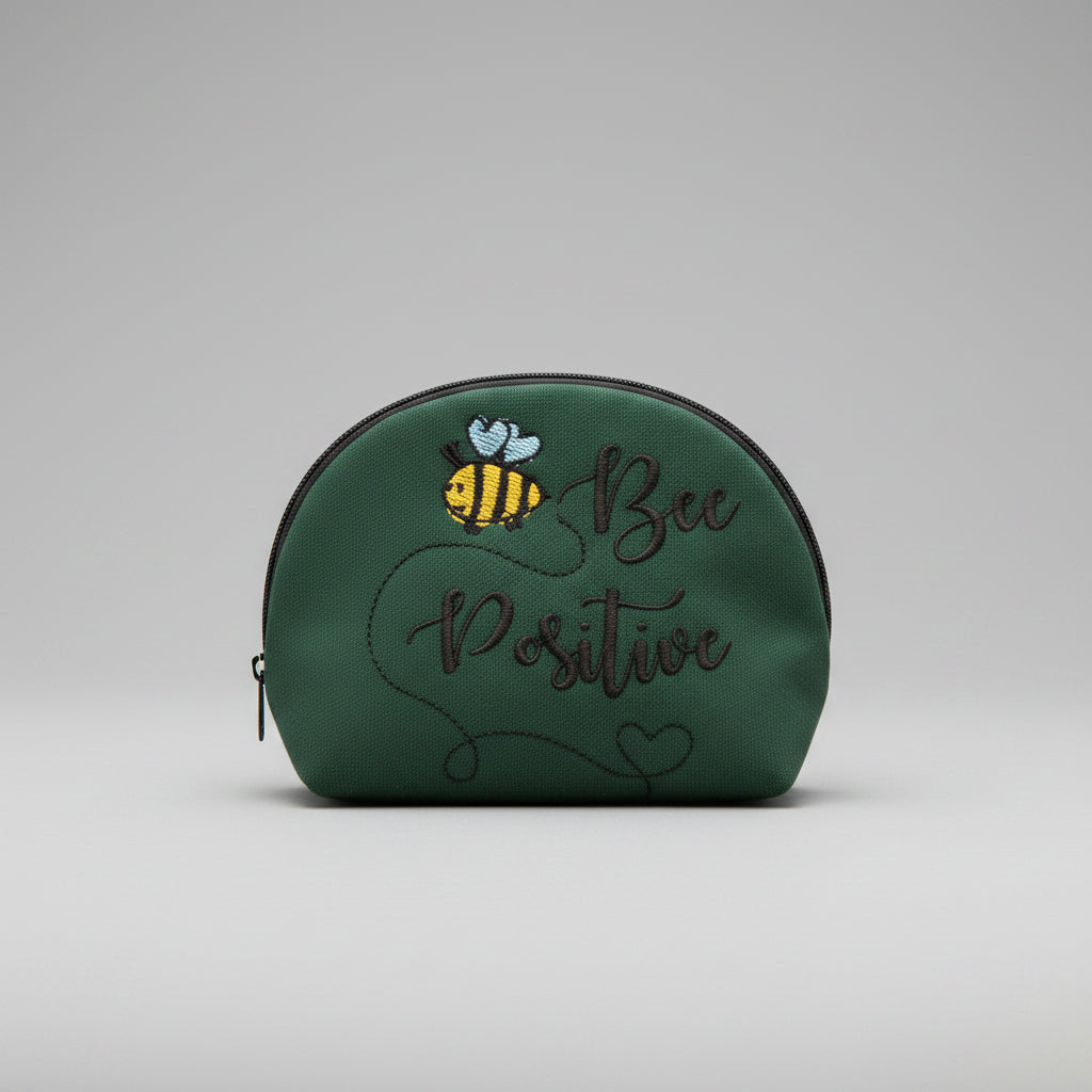 Green cap with bee design and 'Bee Positive' text on a screen with video player interface.