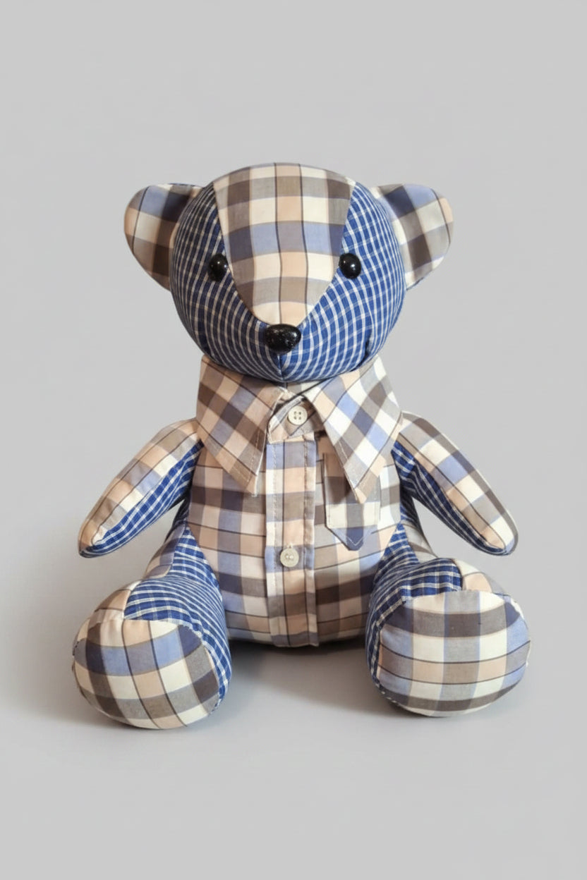 Plaid teddy bear on a gray background