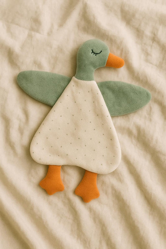 Plush toy duck on a beige fabric background